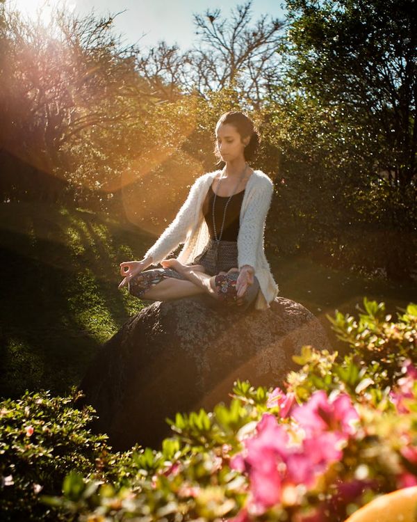 Woman in a calm yoga pose, embodying peace and balance.